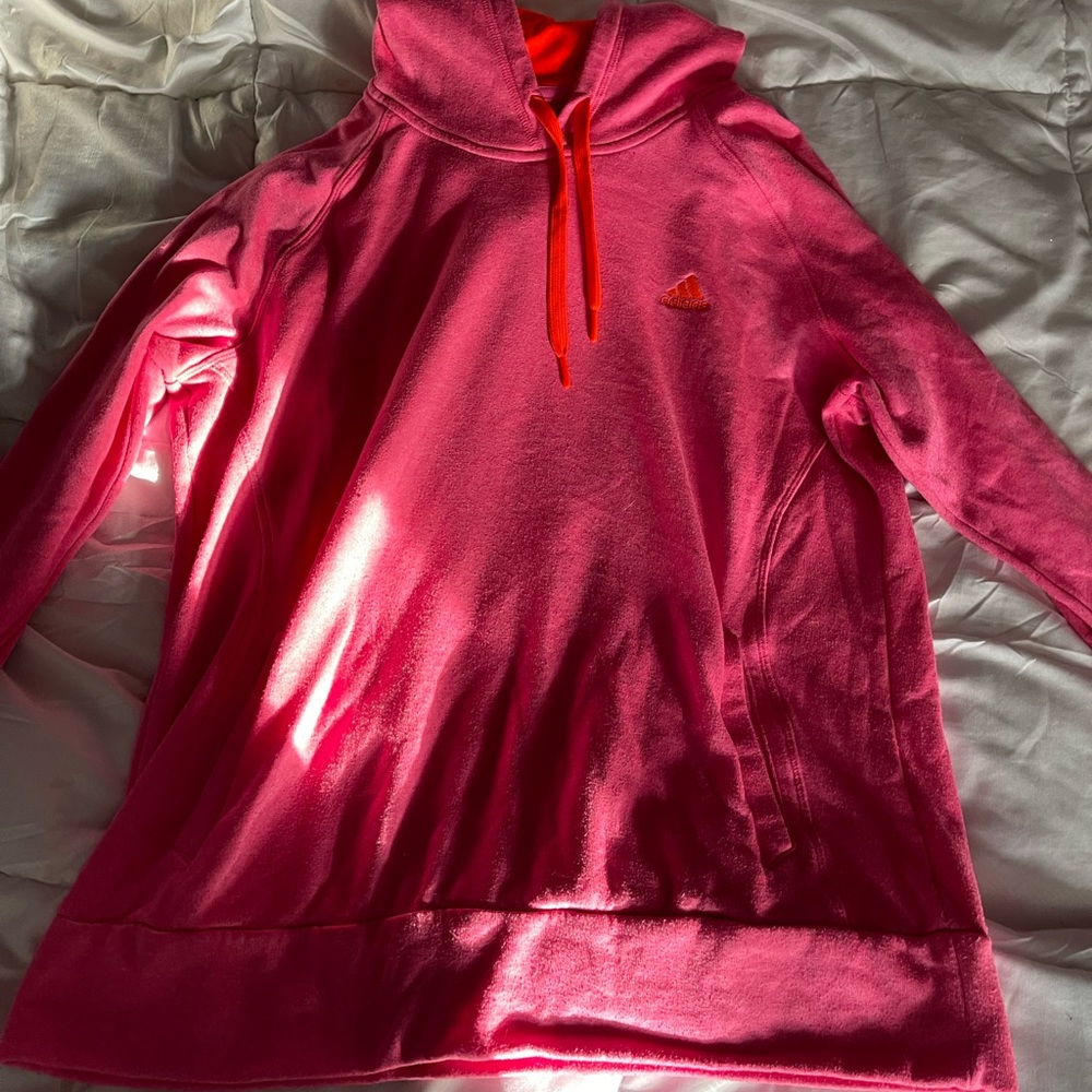 Pink adidas ultimate hoodie with orange details.